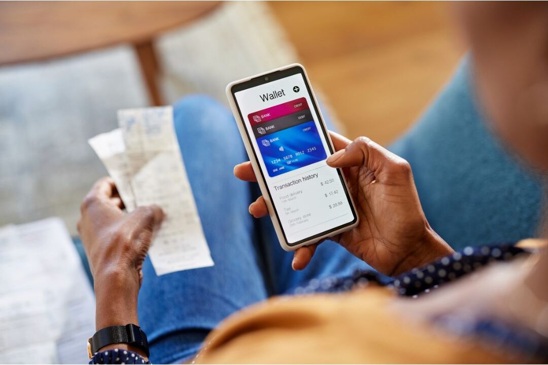 woman checking her personal credit score on a smartphone at home