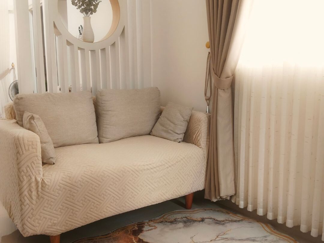 cozy living room corner with thick rug linen curtains and warm lighting showcasing quiet atmosphere