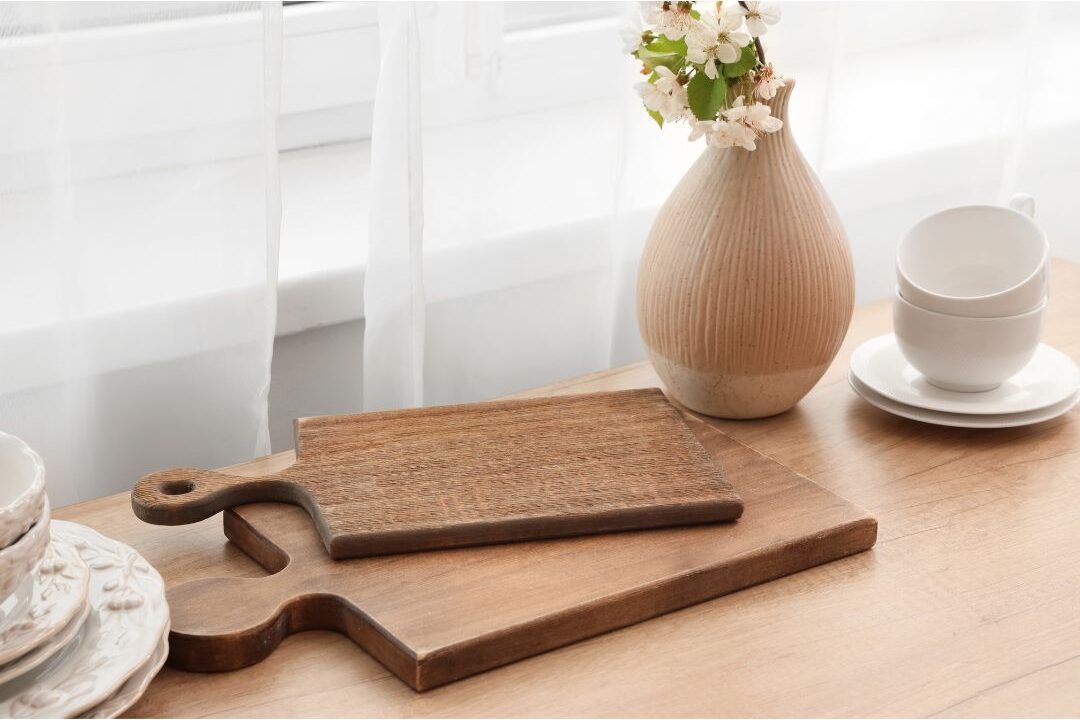 clean organized kitchen counter with wooden cutting board and green vase showing tidy surfaces