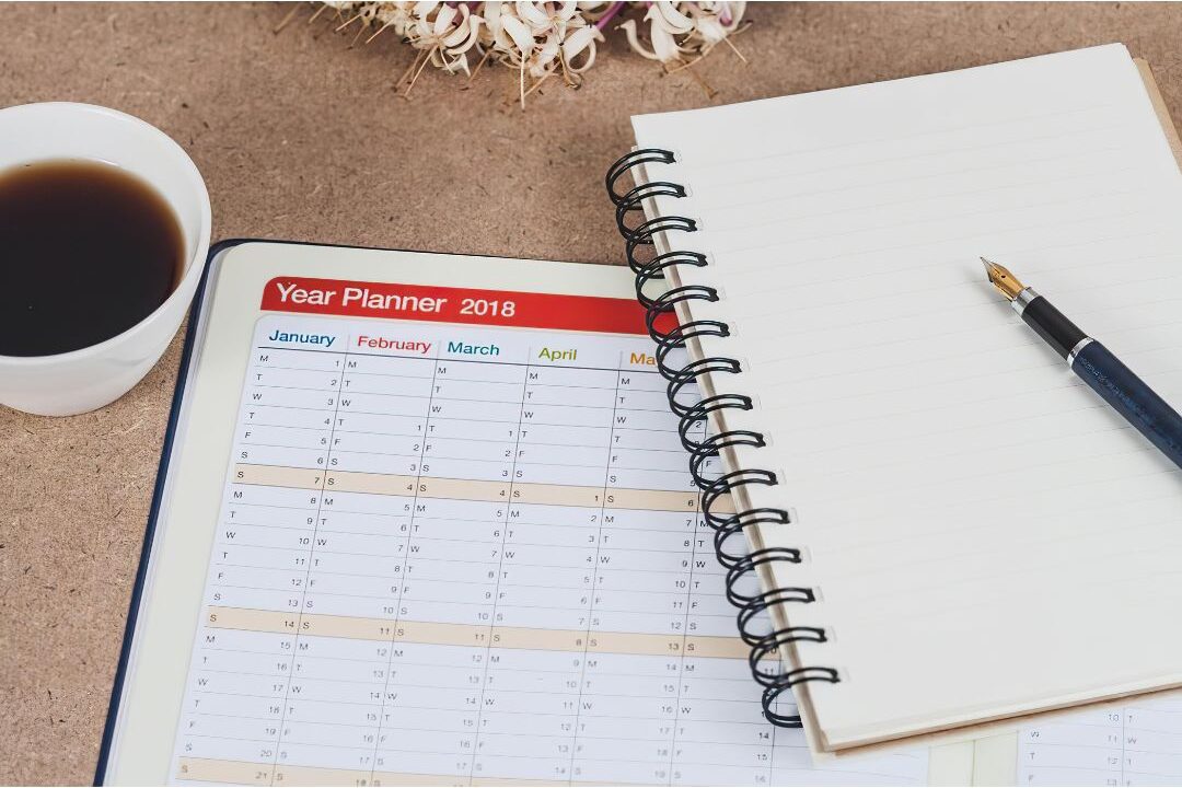 open workbook planner with a coffee cup on a light wooden desk highlighting guided workbook products