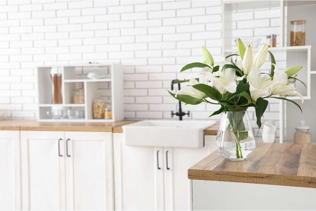 simple clean kitchen counter with a vase of fresh flowers representing simplified home routines