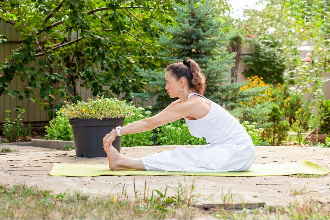 woman stretching gently outdoors in a garden enjoying movement
