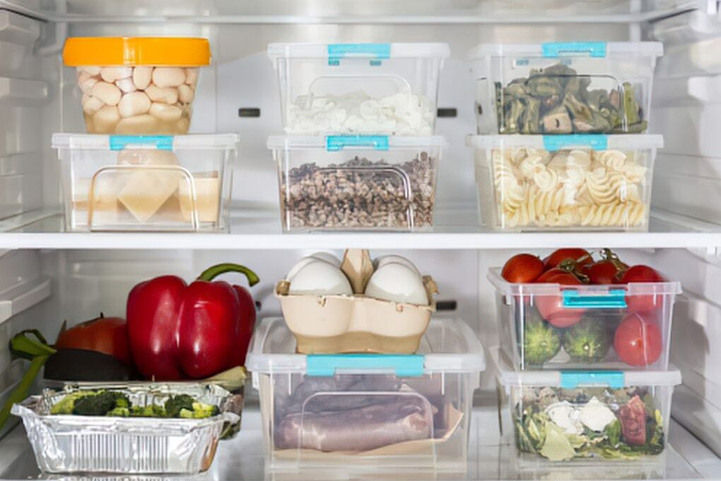 clean organized refrigerator interior with labeled clear glass containers