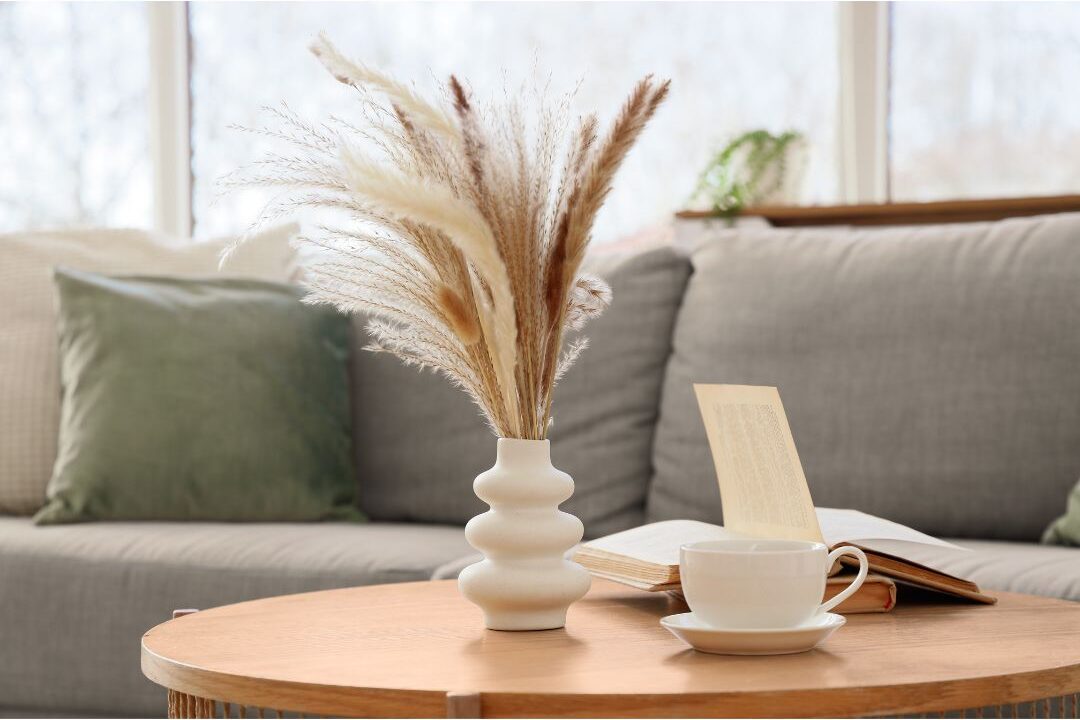 minimalist coffee table styled with wooden tray book stack and vase addressing decor mistakes that make homes look cluttered