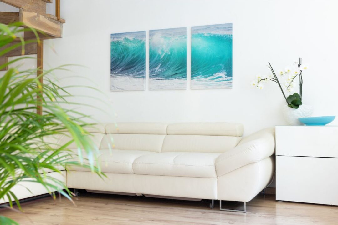 large abstract art piece in a sleek frame hanging above modern sofa, incorporating things that instantly make your home look expensive