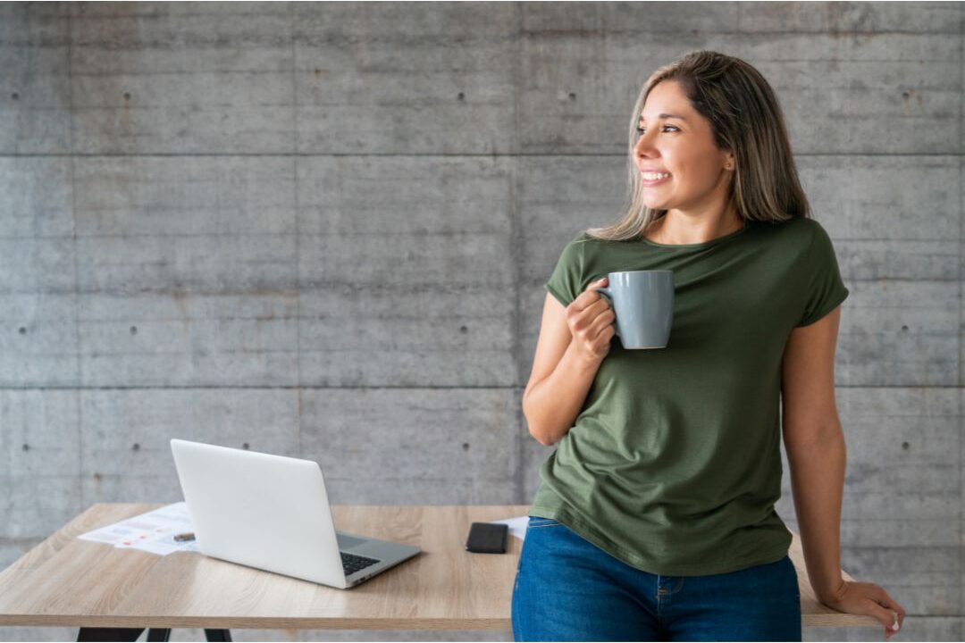 woman taking a peaceful coffee break while working on laptop exploring passive income streams that actually still work