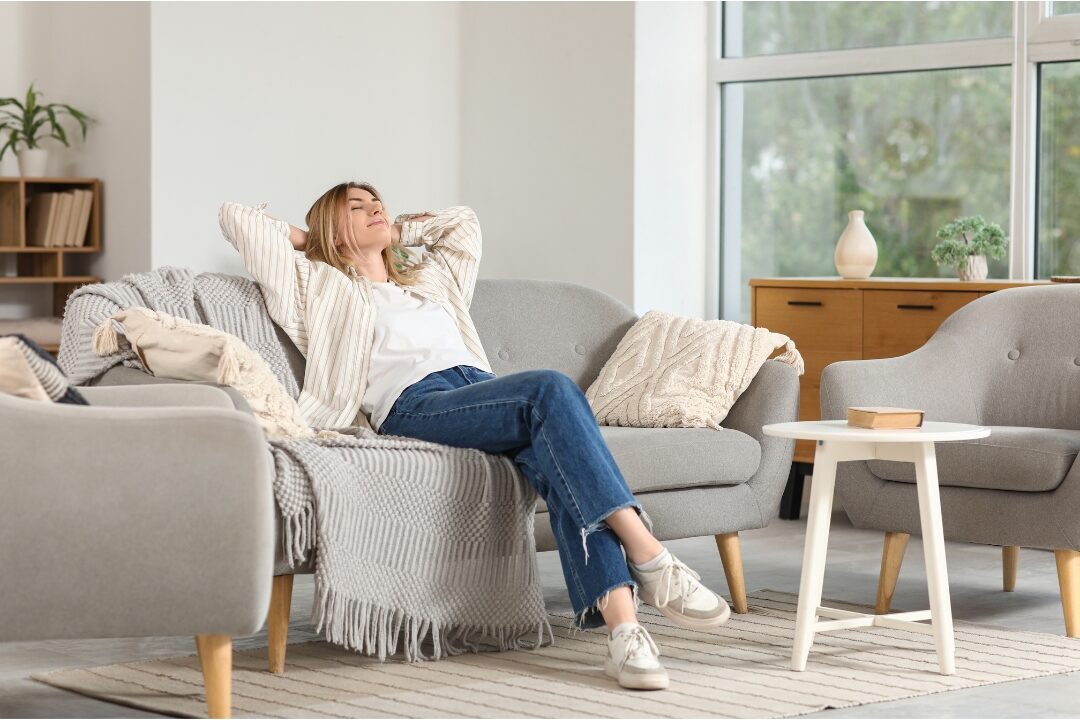 peaceful mother smiling in clean cozy living room discovering simple household rules that eliminate daily stress