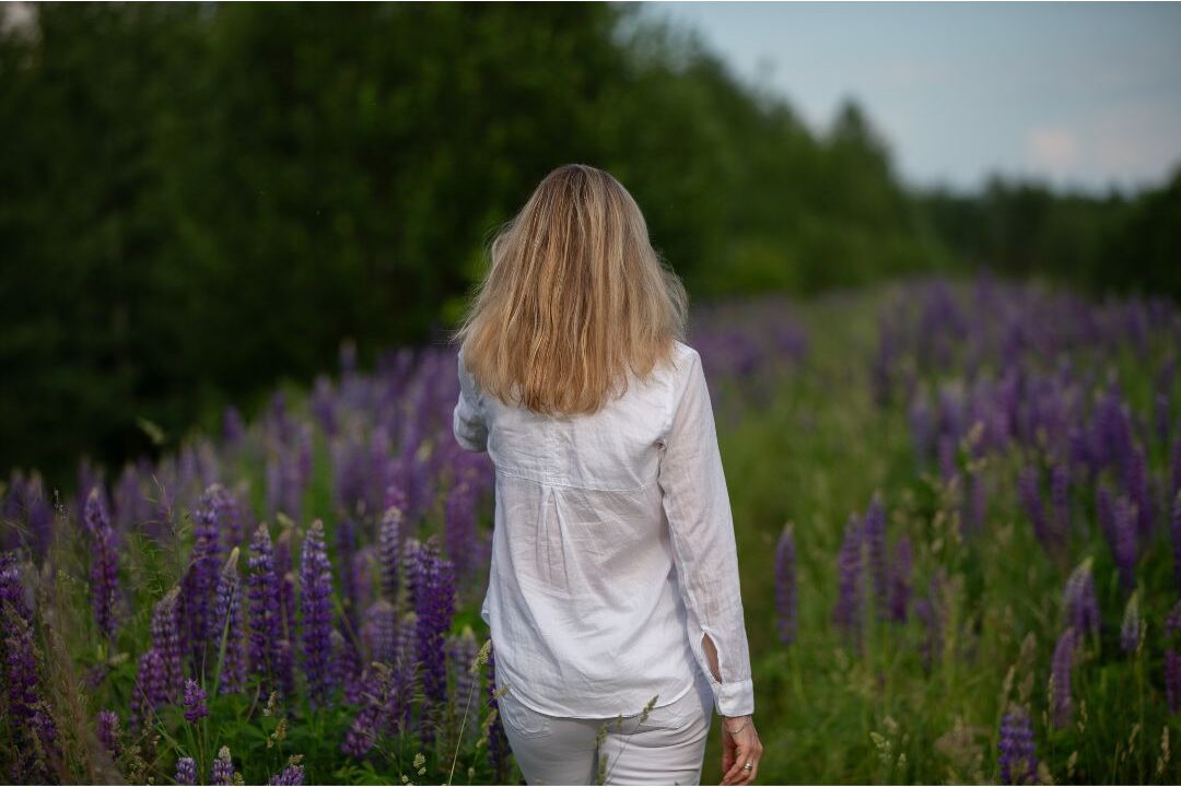 woman walking through quiet garden with soft morning illustrating mental clarity
