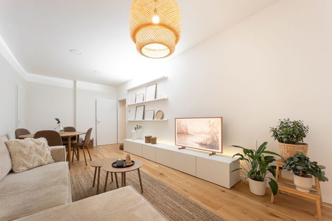 cozy sunlit living room with neutral linen sofa and warm wood coffee table creating calm atmosphere