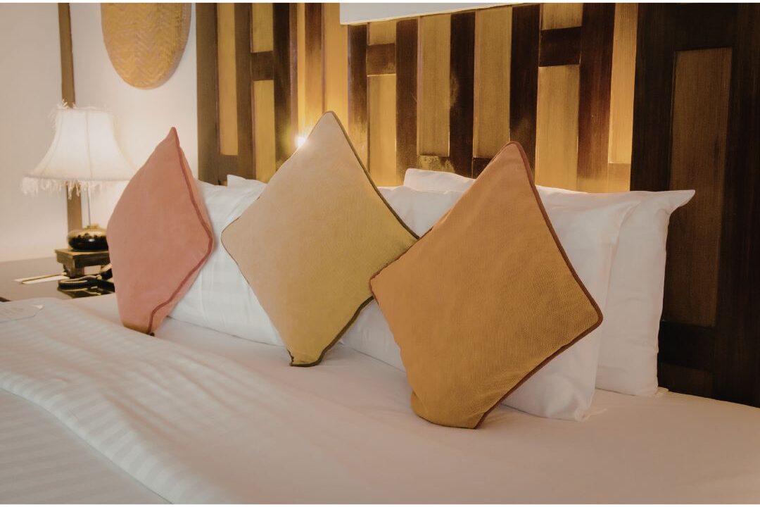 cozy bedroom scene with soft throws and warm lamp lighting demonstrating biological rest