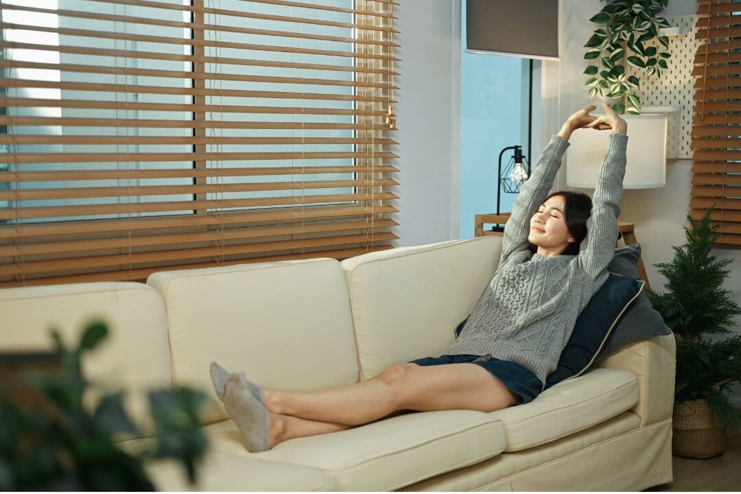 relaxed woman resting in cozy home setting after learning why you never finish your to-do list