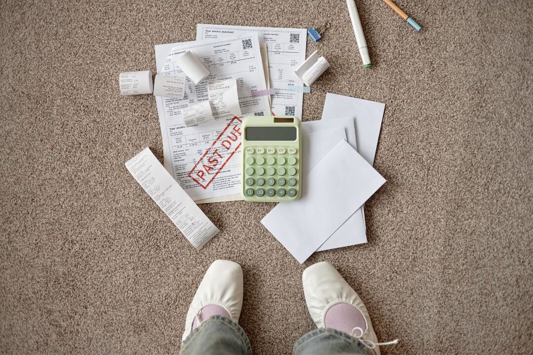stressful stack of household bills on the floor