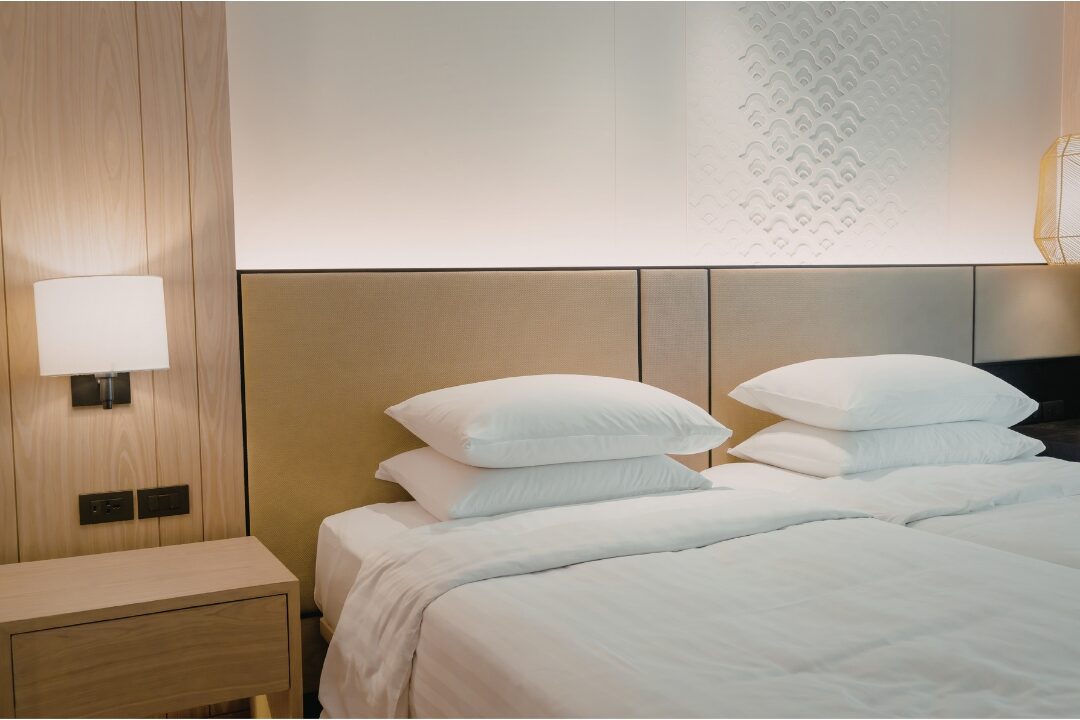 serene master bedroom with clean white bedding applying simple household rules that eliminate daily stress