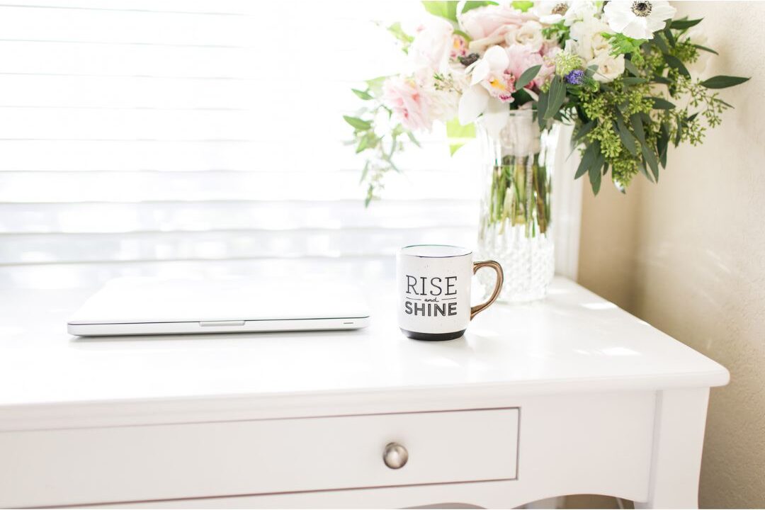 clean organized home desk with laptop and small green vase showing clear spatial boundaries
