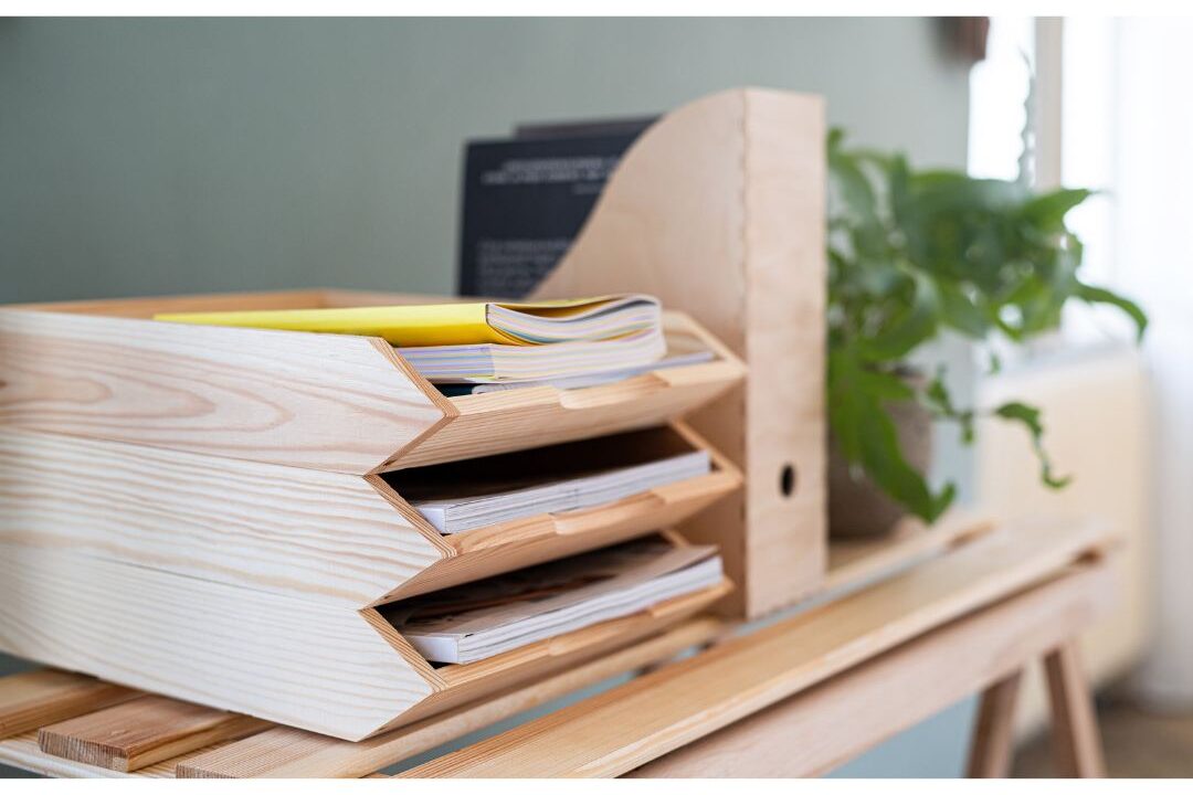 wooden paper inbox tray sitting on clean office desk displaying paper management