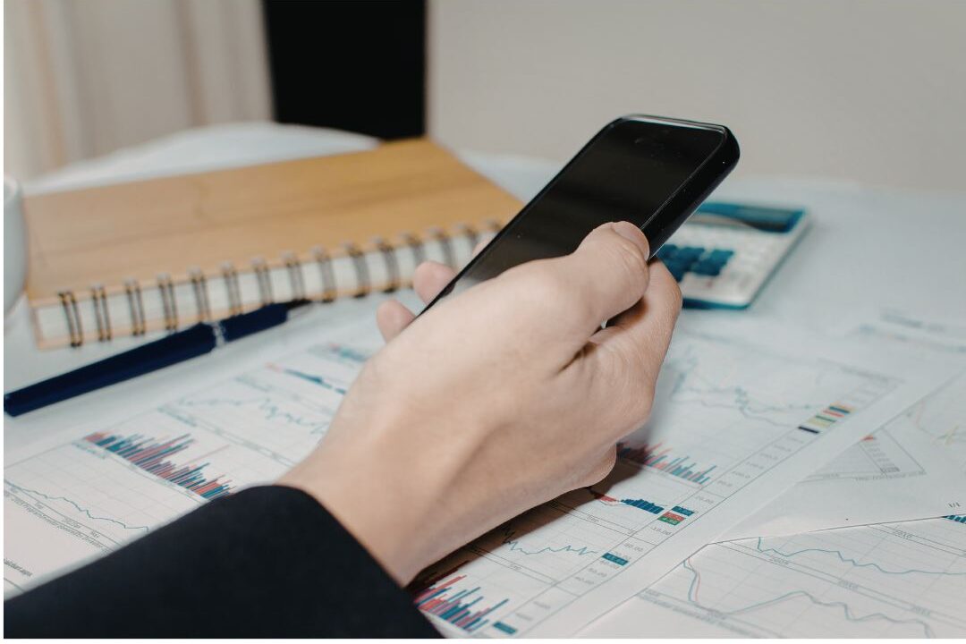 smartphone lying on daily planner illustrating why you never finish your to-do list