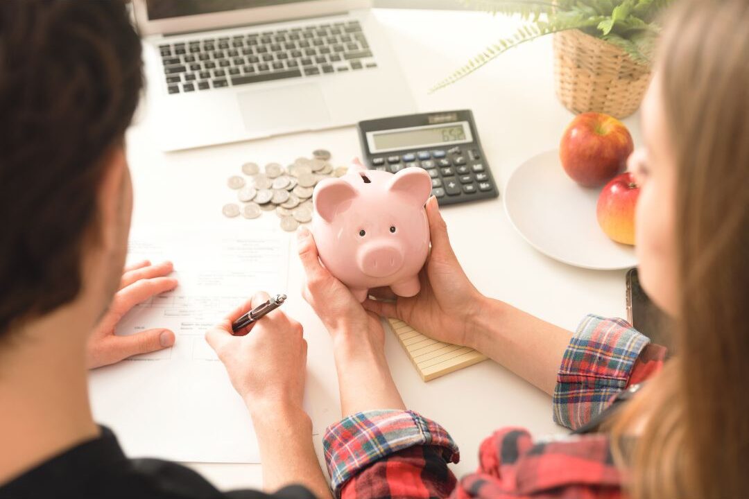 woman holding a piggy bank reviewing money mistakes stay-at-home moms make regarding retirement
