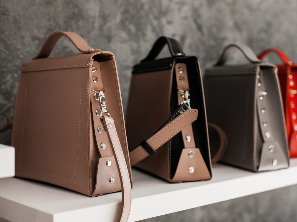 close up of smooth brown leather tote bag with brass hardware showing quality accessories