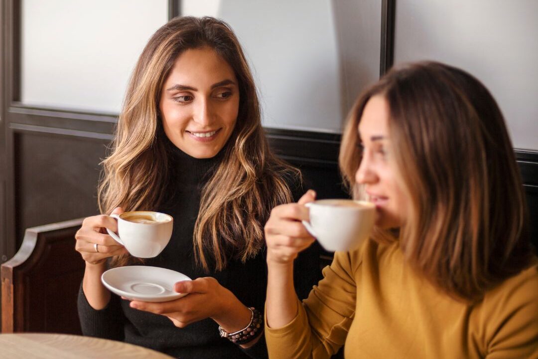 two women having a real heartfelt conversation over tea