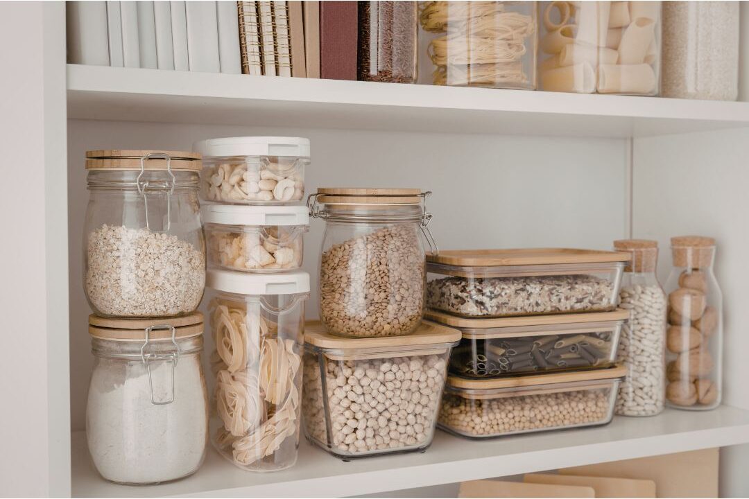 neat bulk dry food containers in a wood kitchen pantry