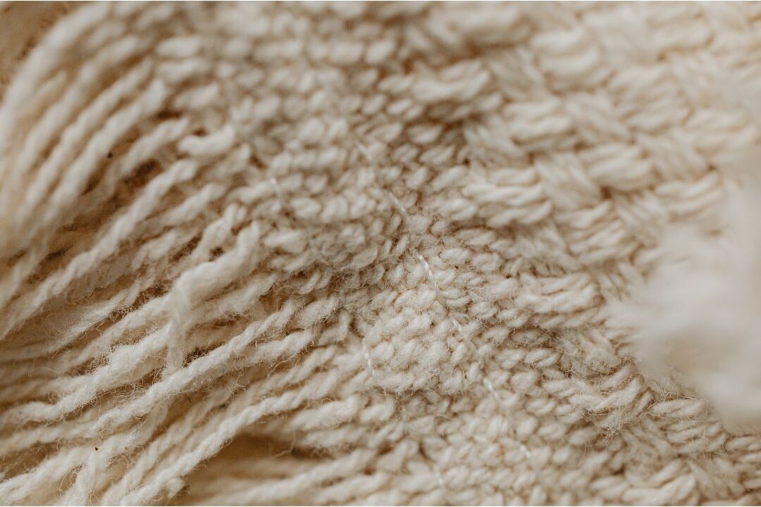 close up of textured beige woven blanket showing textile details