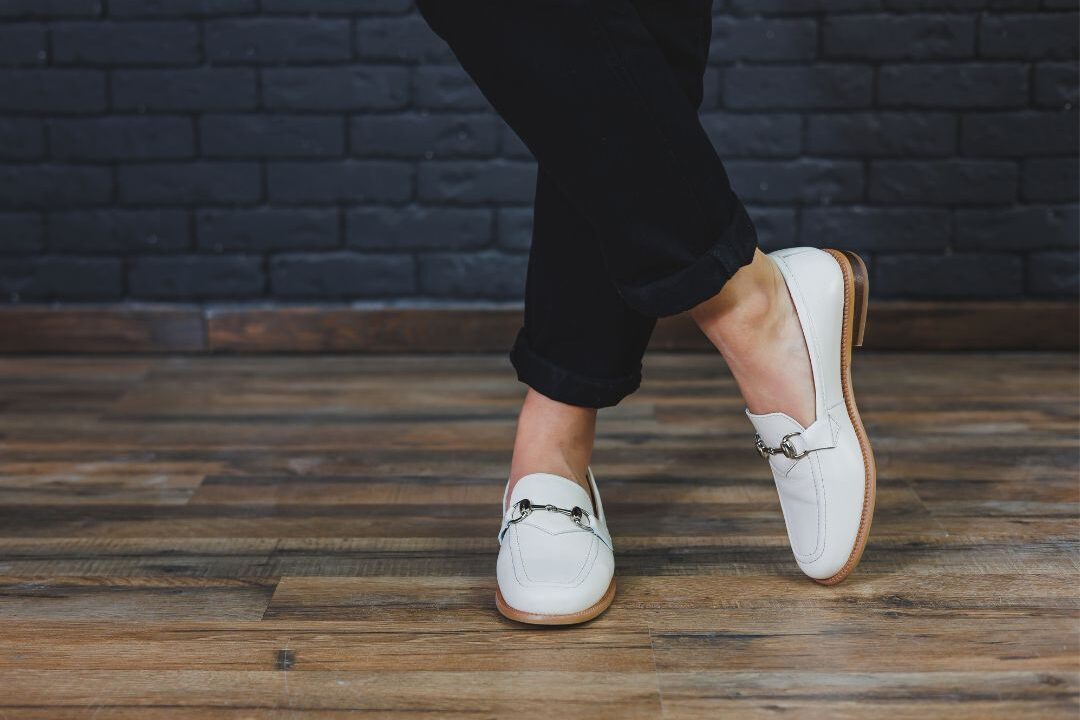 pair of elegant tan leather loafers resting on stone step illustrating comfortable footwear