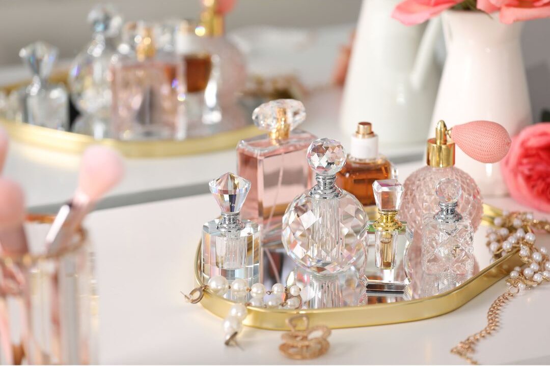 neatly organized vanity mirror with elegant glass perfume bottles showing curated styling details