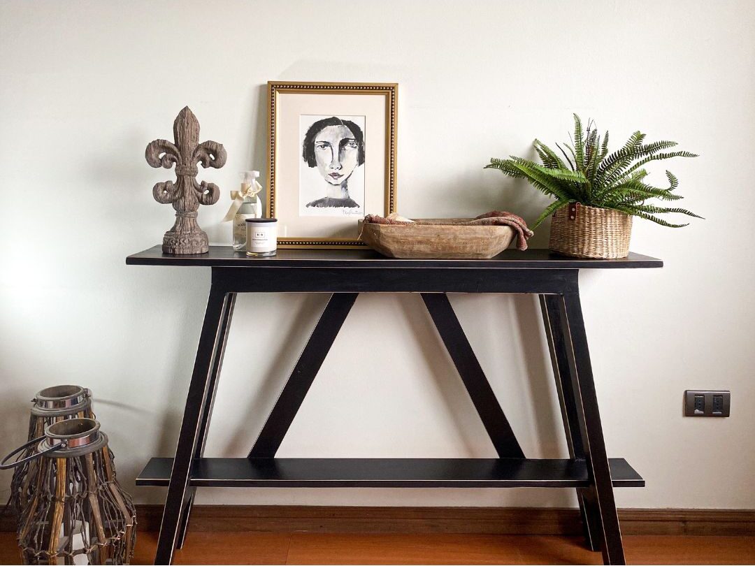 minimalist entry console with wooden bowl and framed artwork illustrating interior harmony