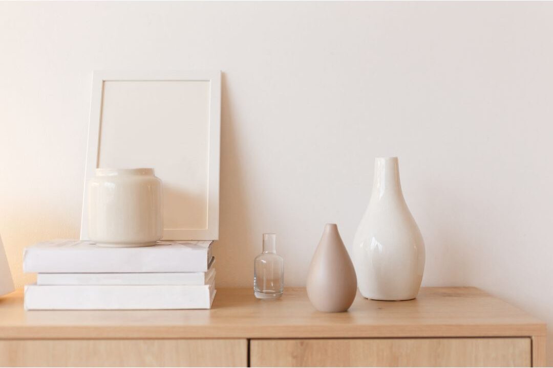 minimalist styled shelf with neutral vase and book stack demonstrating things that instantly make your home look expensive