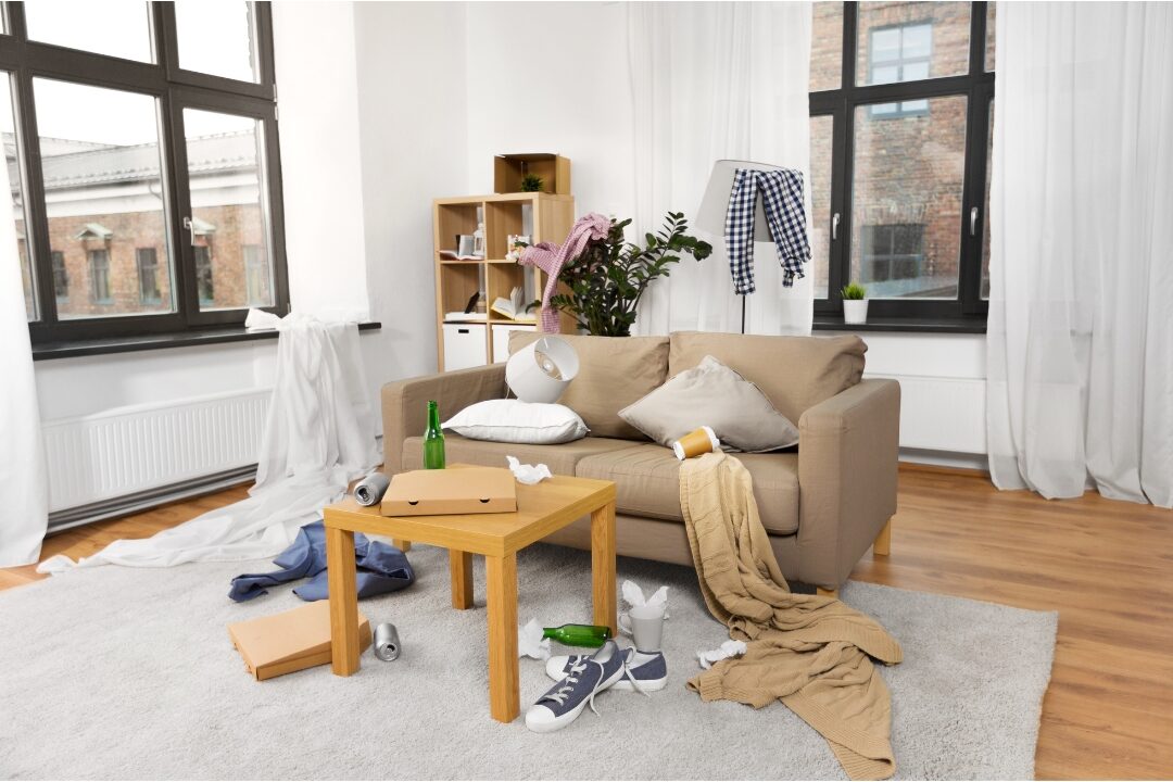 cluttered living room table with scattered items demonstrating why conventional organizing fails