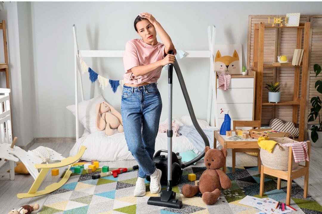 woman looking at messy living room counter thoughtfully reflecting on domestic stress