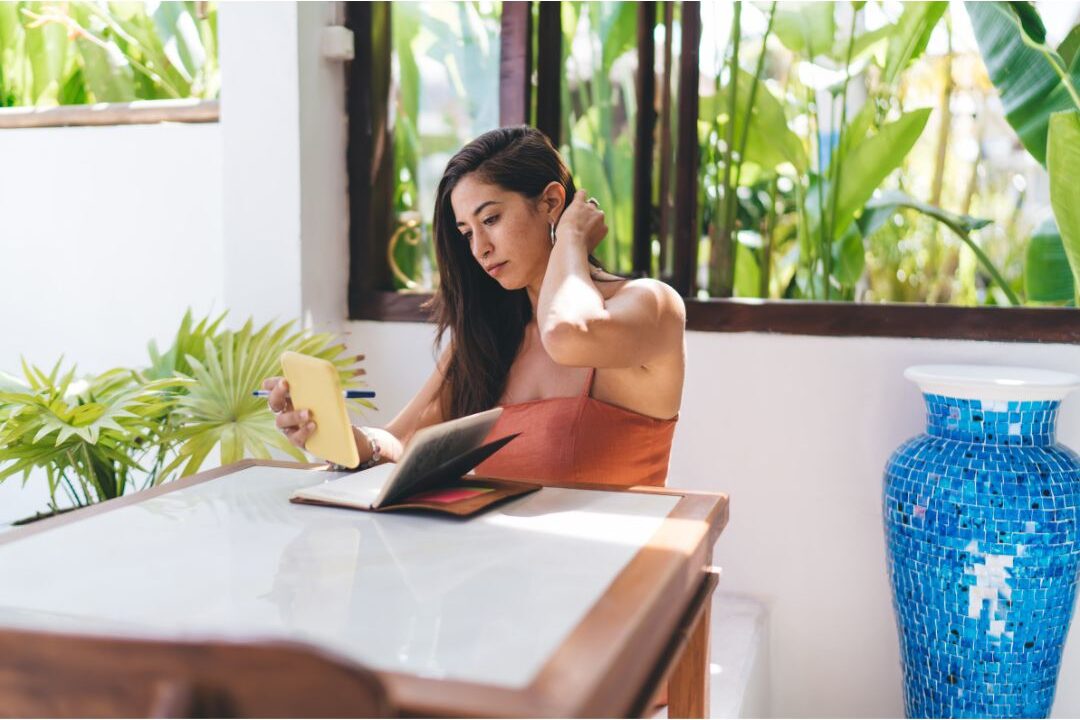 peaceful woman looking at planner at bright table finding out why you never finish your to-do list