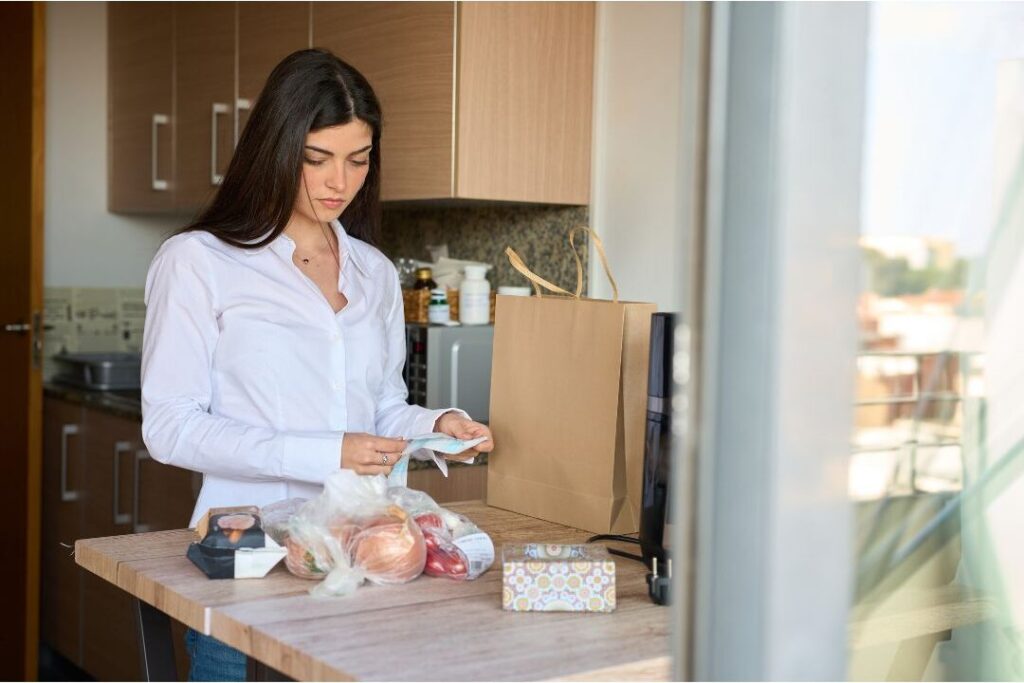 mother reviewing receipts showing how to save money even if you're living paycheck to paycheck