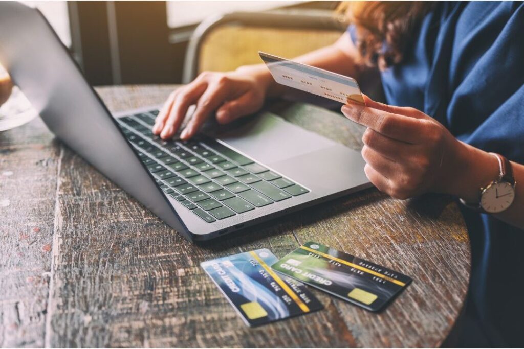 woman auditing monthly subscriptions on laptop to stop money leaks