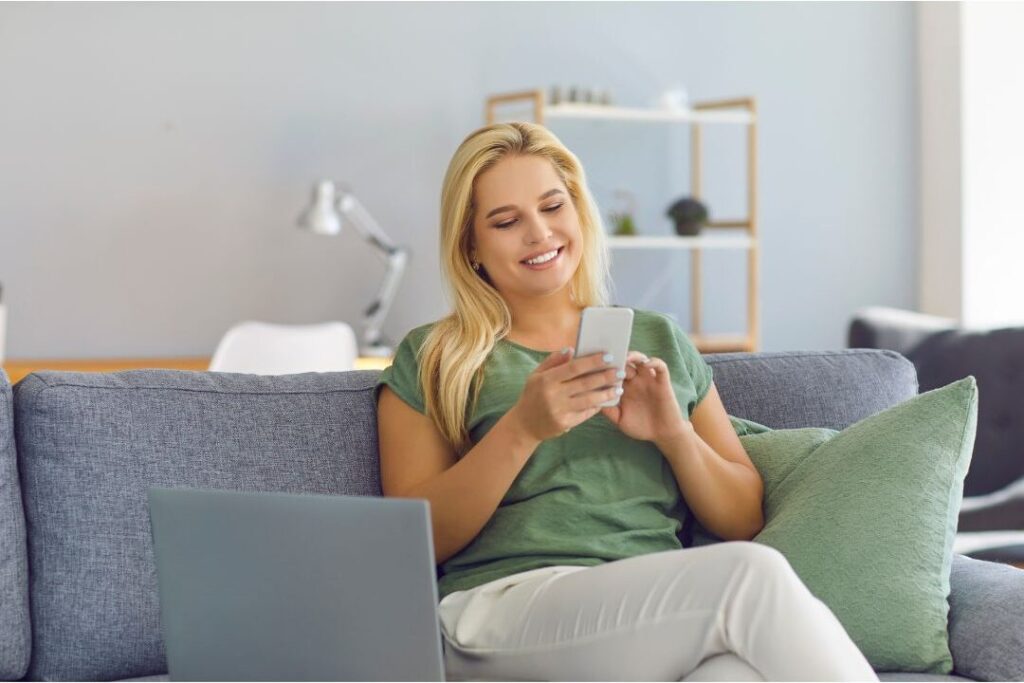 mother using banking app automating savings to learn how to save money even if you're living paycheck to paycheck