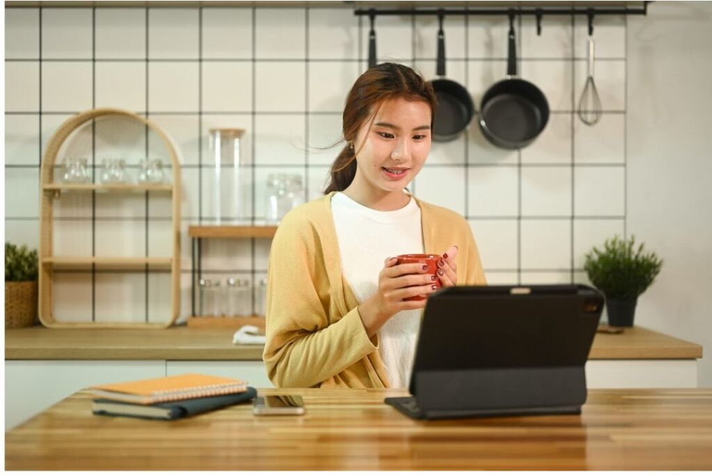 woman managing household finances on digital tablet showing the soft life checklist i wish every mom had before having kids