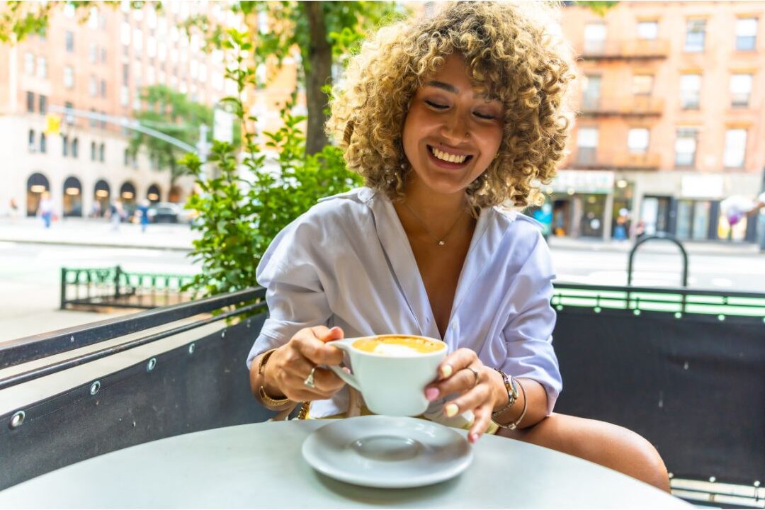 relaxed woman enjoying a quiet coffee date outdoors alone highlighting 60 soft life ideas every mom should try