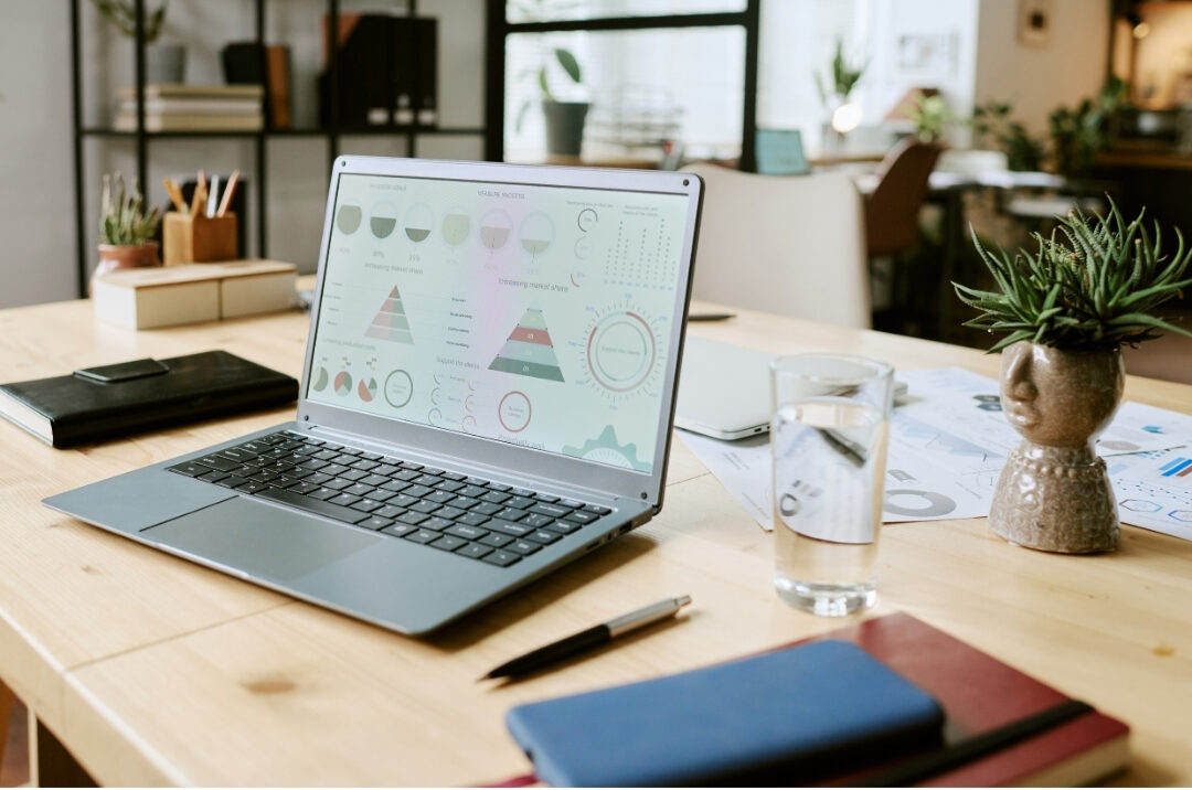 desk with laptop open showing professional document beside quiet lamp keeping focus clean