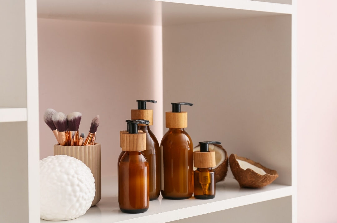 open bathroom cabinet showing organized skincare bottles on wooden shelves