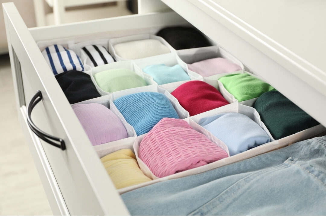 tidy bedroom dresser drawer with folded t-shirts arranged vertically