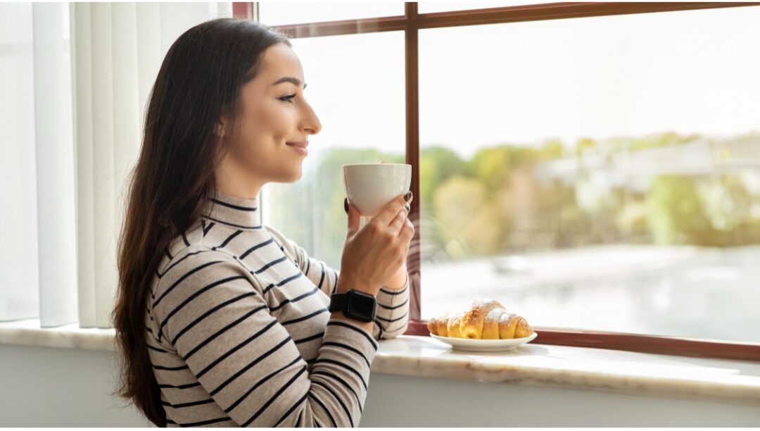 woman taking a peaceful moment to sip warm coffee outdoors releasing maternal martyrdom