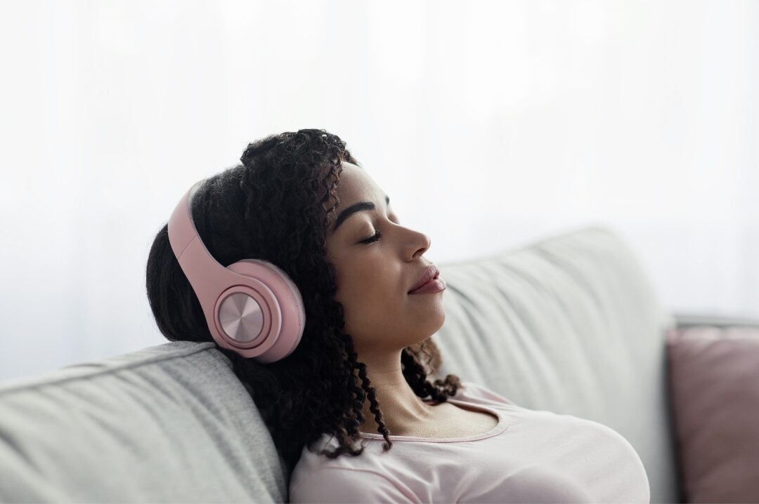 woman resting peacefully on comfortable sofa with eyes closed prioritizing restorative breaks