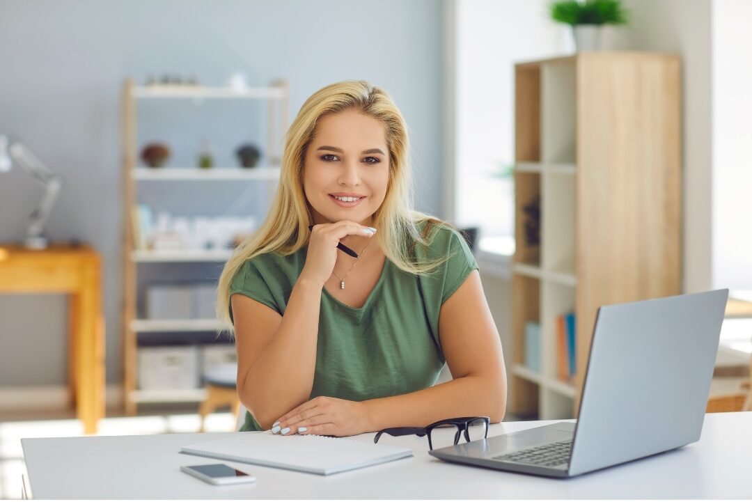 confident woman in her late thirties smiling warmly in bright studio pursuing new career path