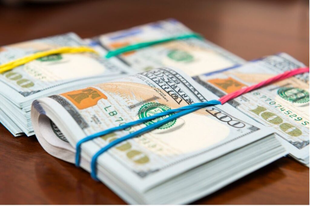 stack of bills showing emergency fund buffer when you never have money left over