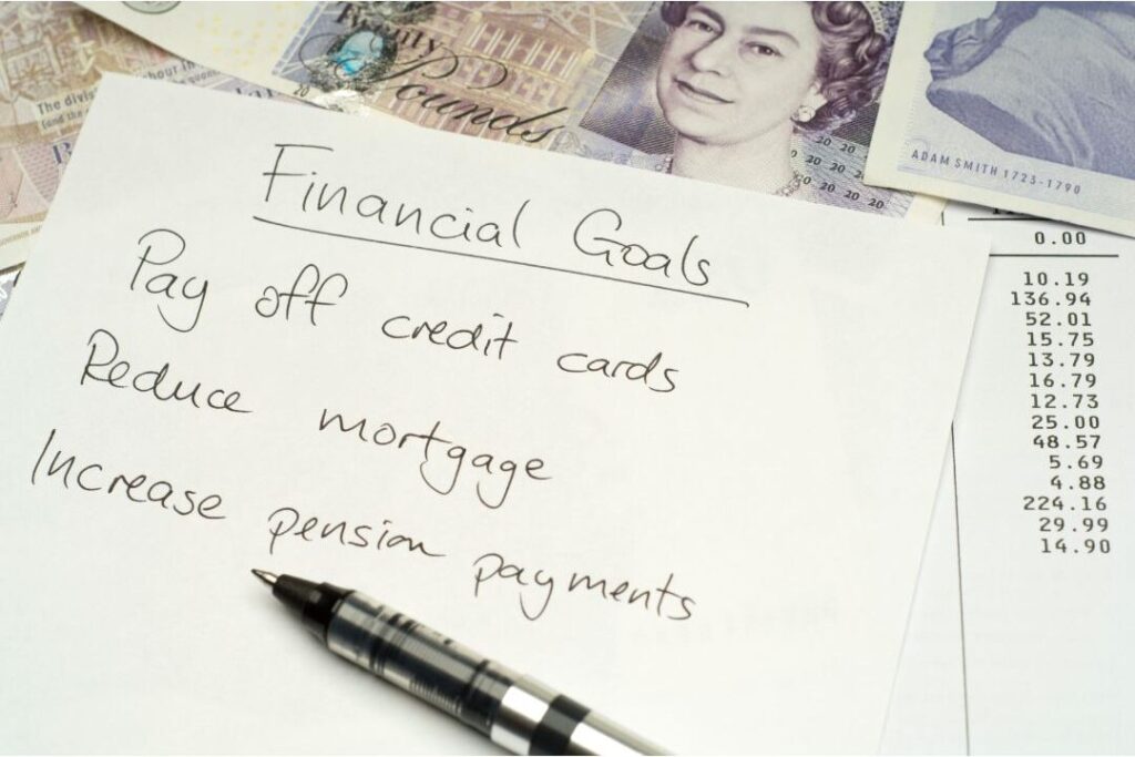 person writing financial goals capping lifestyle baseline