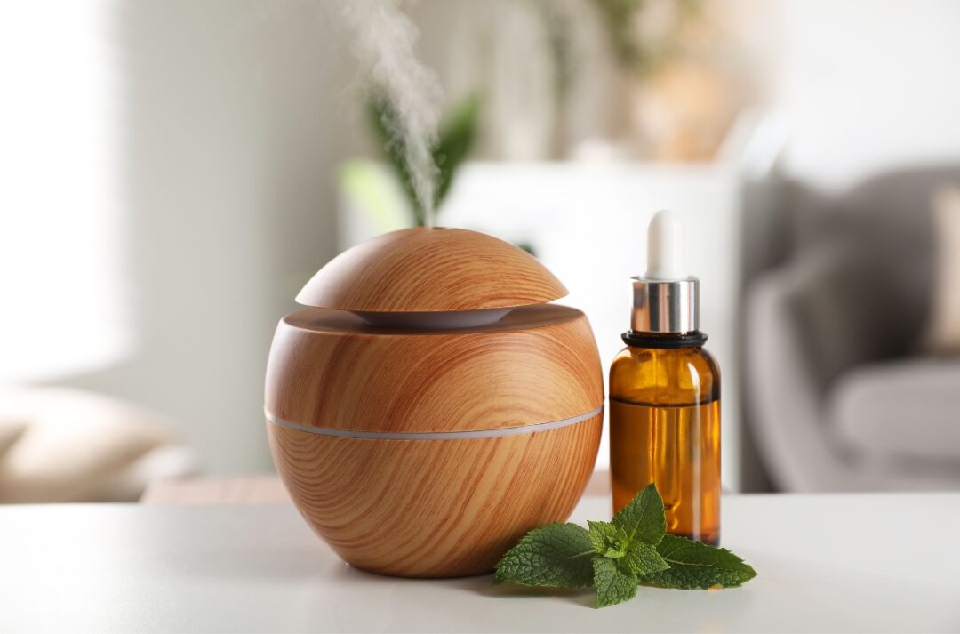 minimalist ceramic essential oil diffuser sitting on wooden side table