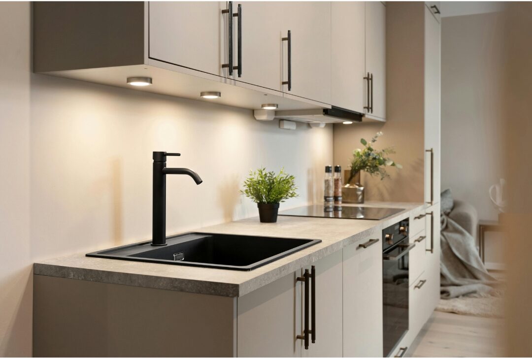 clean tidy kitchen counter with empty sink exploring 30 tiny luxuries every woman deserves