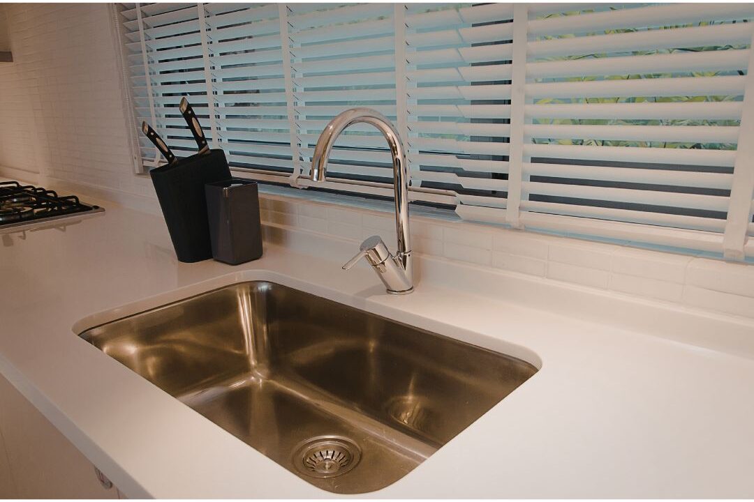 spotless clean stainless steel kitchen sink with warm soft light exploring 45 daily habits that make life easier