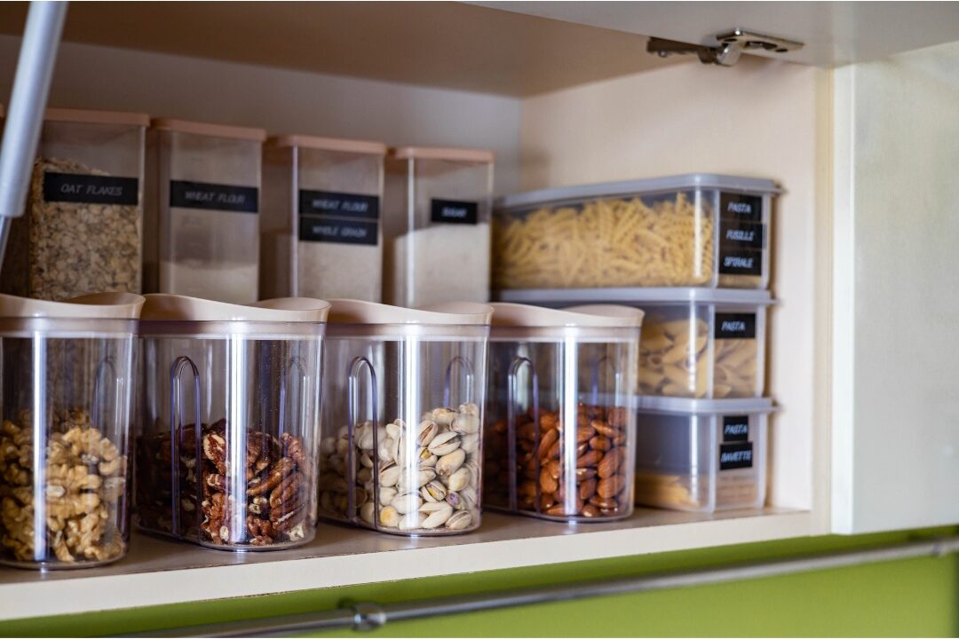 clear glass food storage containers stacked neatly on kitchen shelf