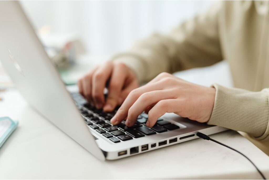 digital-communication-batching-weekly-planning.jpg, Alt text: "close up of person typing neatly organized weekly plan on laptop
